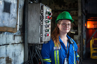 Co-op student on a job site with a hard hat on