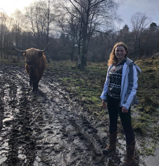 Nicole smiling with an ox behind her