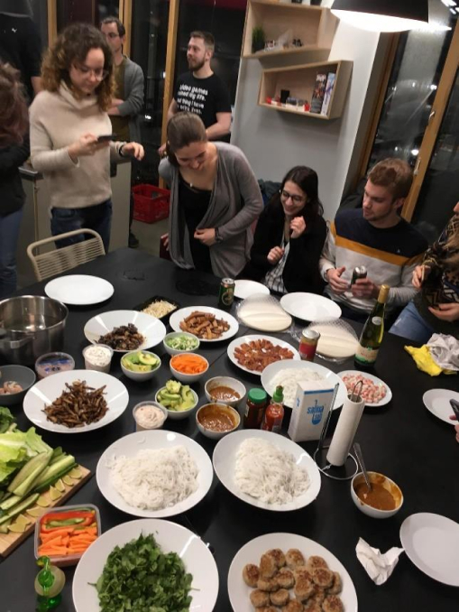 Students sitting in front of a table full of food