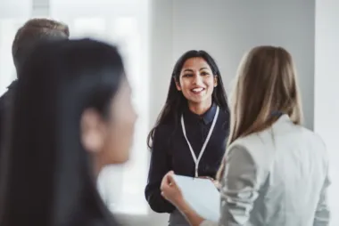 Two women talking at a networking event
