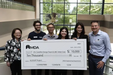 UBC Orbit being awarded with a cheque of ten thousand dollars.