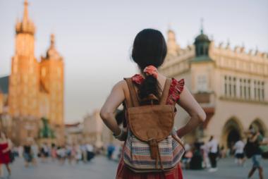 Backside view of girl travelling with backpack