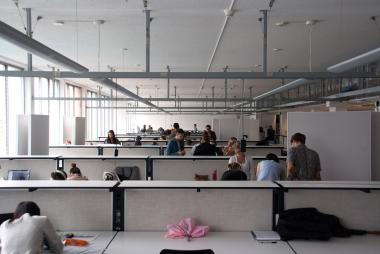 employees working at desks in open office area