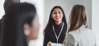 Two women talking at a networking event