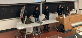 Open Robotics team members giving a talk at the front of the classroom