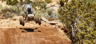 ATV in the air on a dirt track at the SAE California competition.
