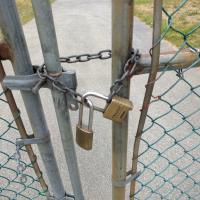 GasGun - Lock is intertwined between two ends of the gates.
